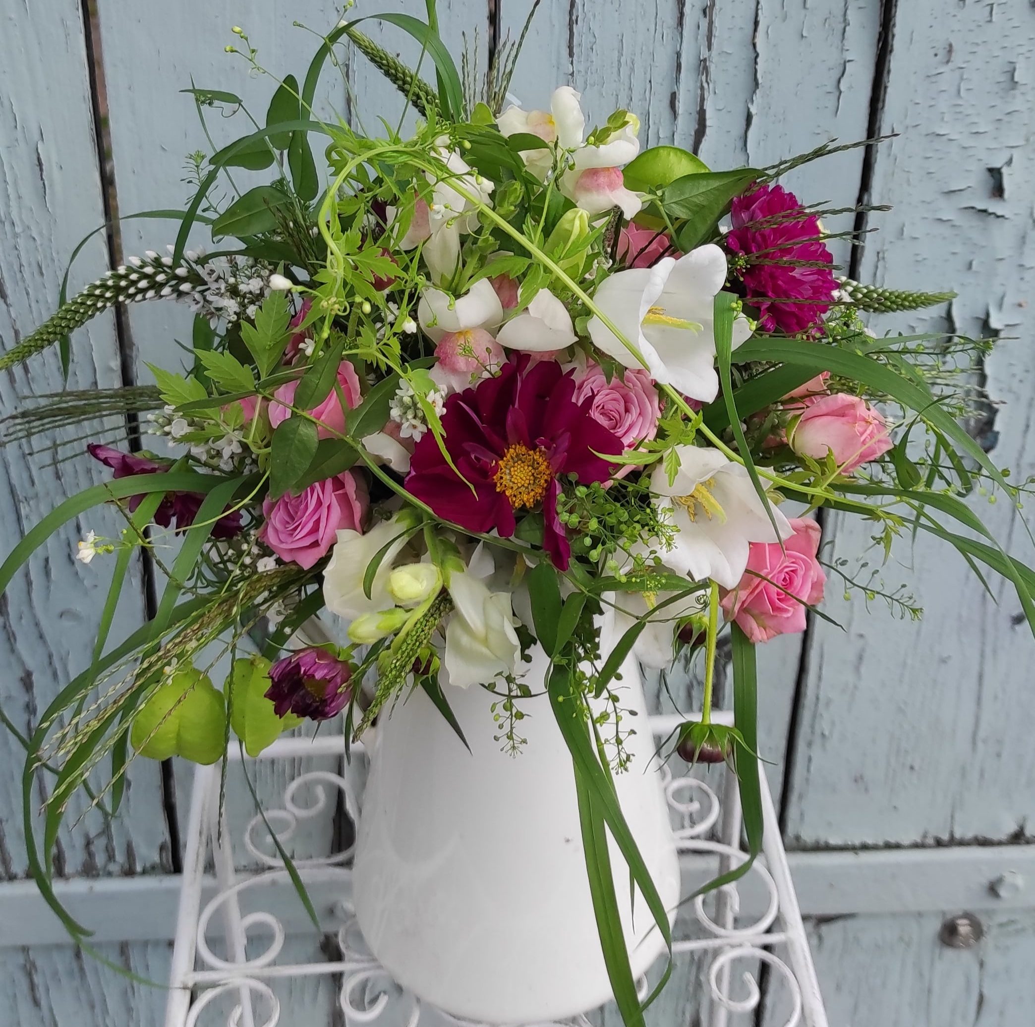 Romantischer Rosenstrauß in einer Holzkiste mit Aufschrift Garden Seasons